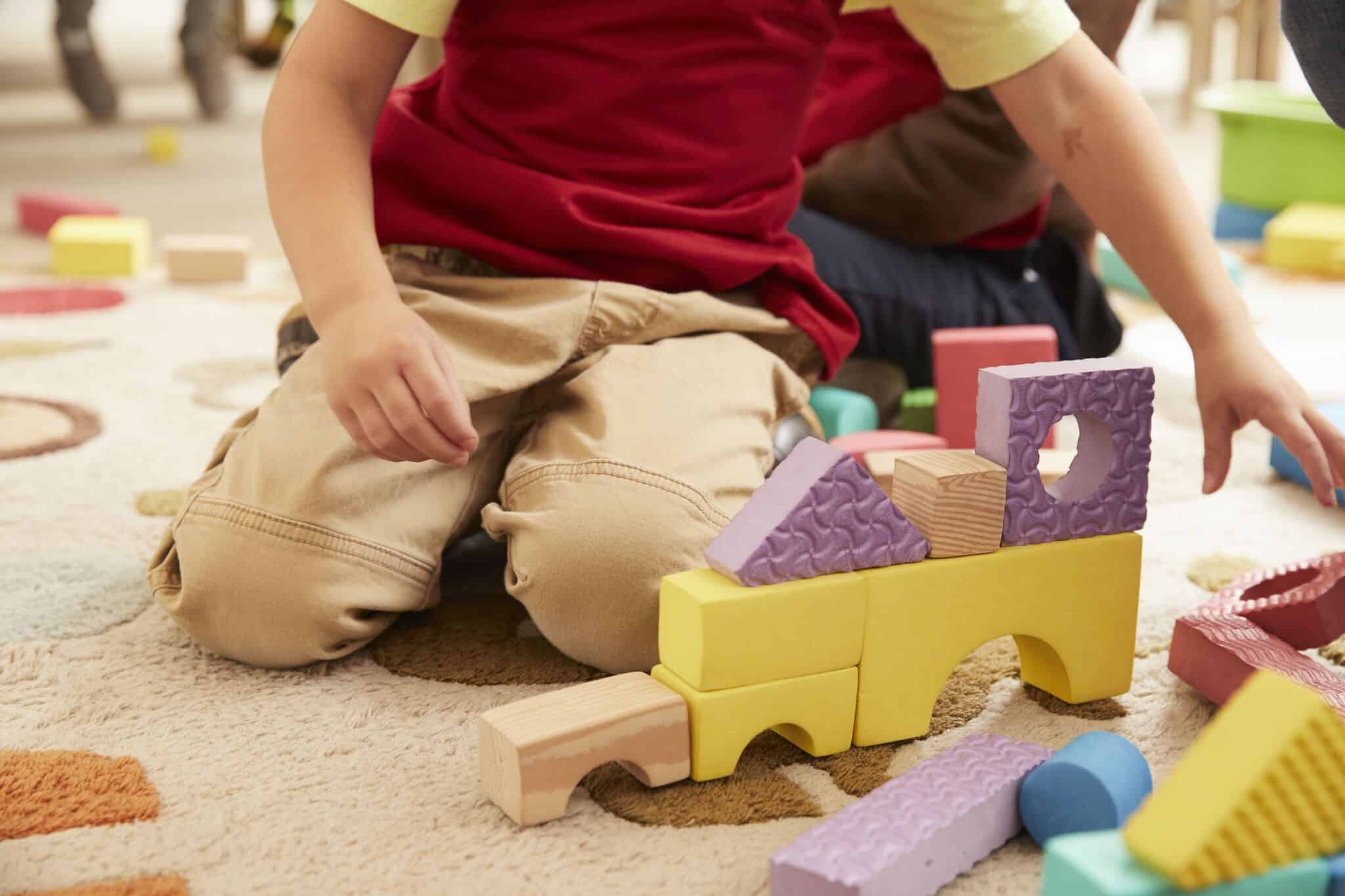 Lonely Child Playing Blocks Alone During COVID-19 Crisis