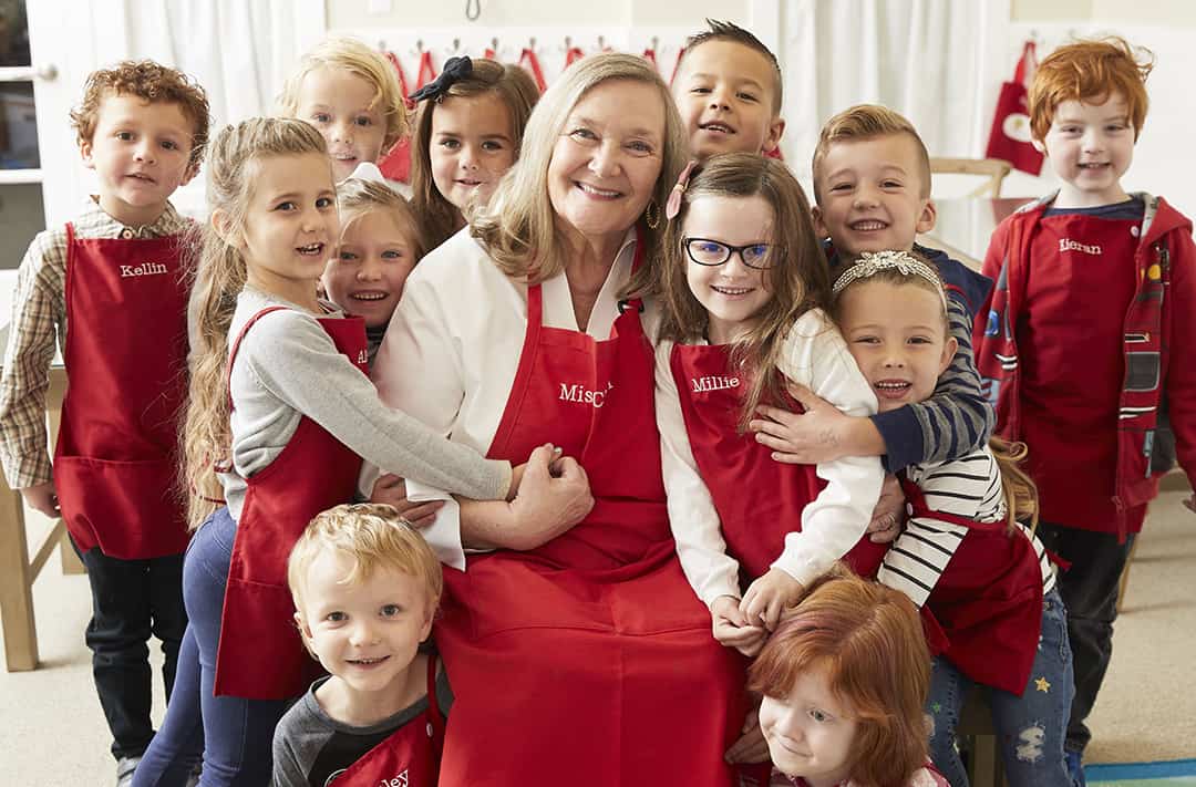 Kids Village Teacher Surrounded and hugged by kids giving positive affirmations for kids Kids Village Teacher Surrounded and hugged by kids giving positive affirmations for kids