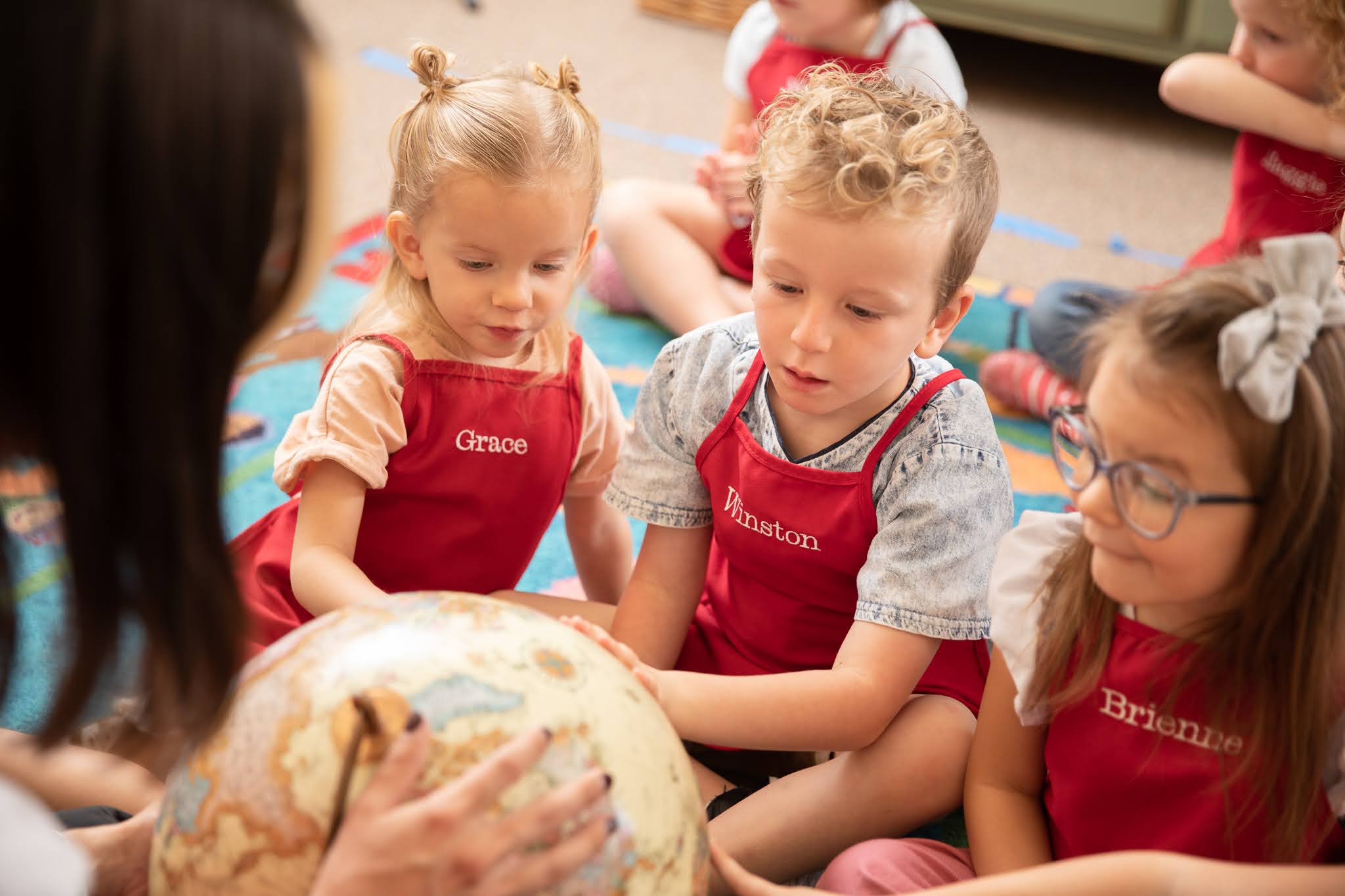 Children with adventurous spirits looking at globe