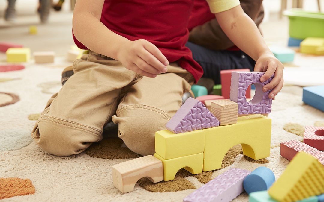 Children building blocks on floor representing building life skills