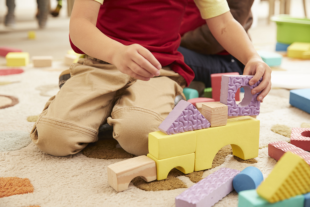 Children building blocks on floor representing building life skills