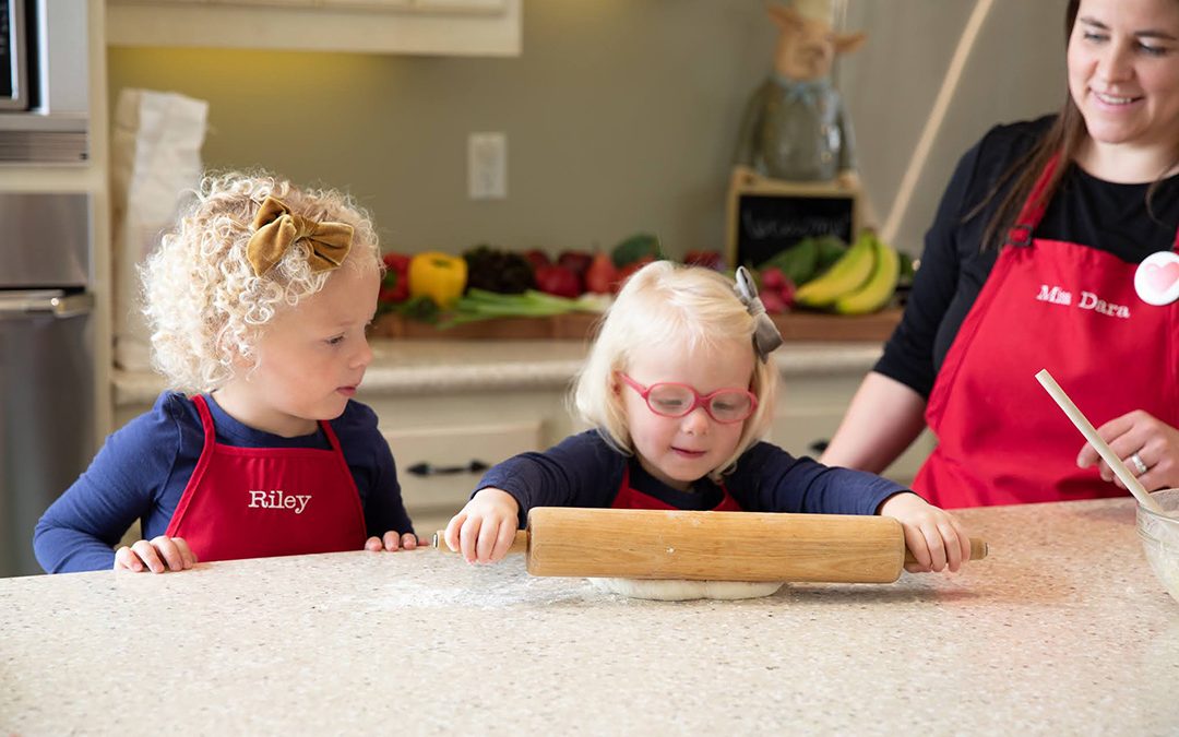 Kids rolling dough in kitchen illustrating home learning activities for kindergarteners