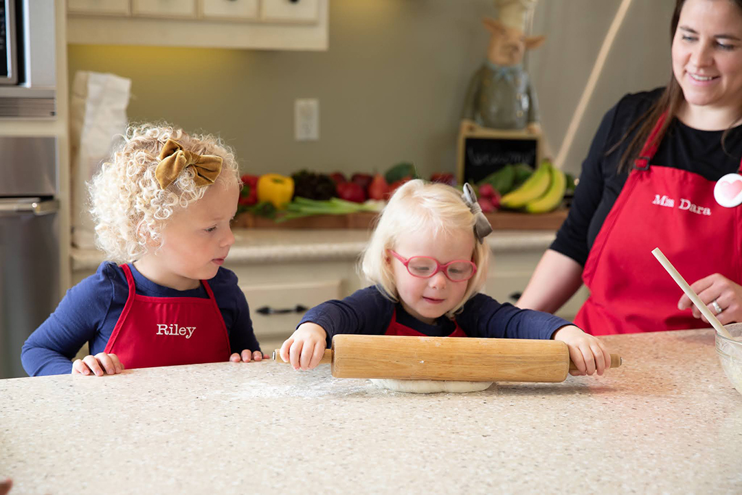 home learning kindergarten activities Kids rolling dough in kitchen illustrating home learning activities for kindergarteners