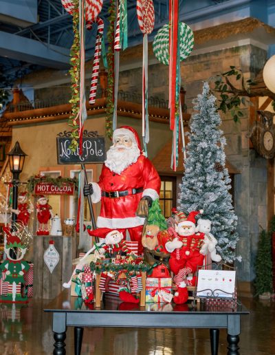 Christmas decorations on a table in front of beautifully decorated kids village private school (preschool and kindergarten) entry foyer