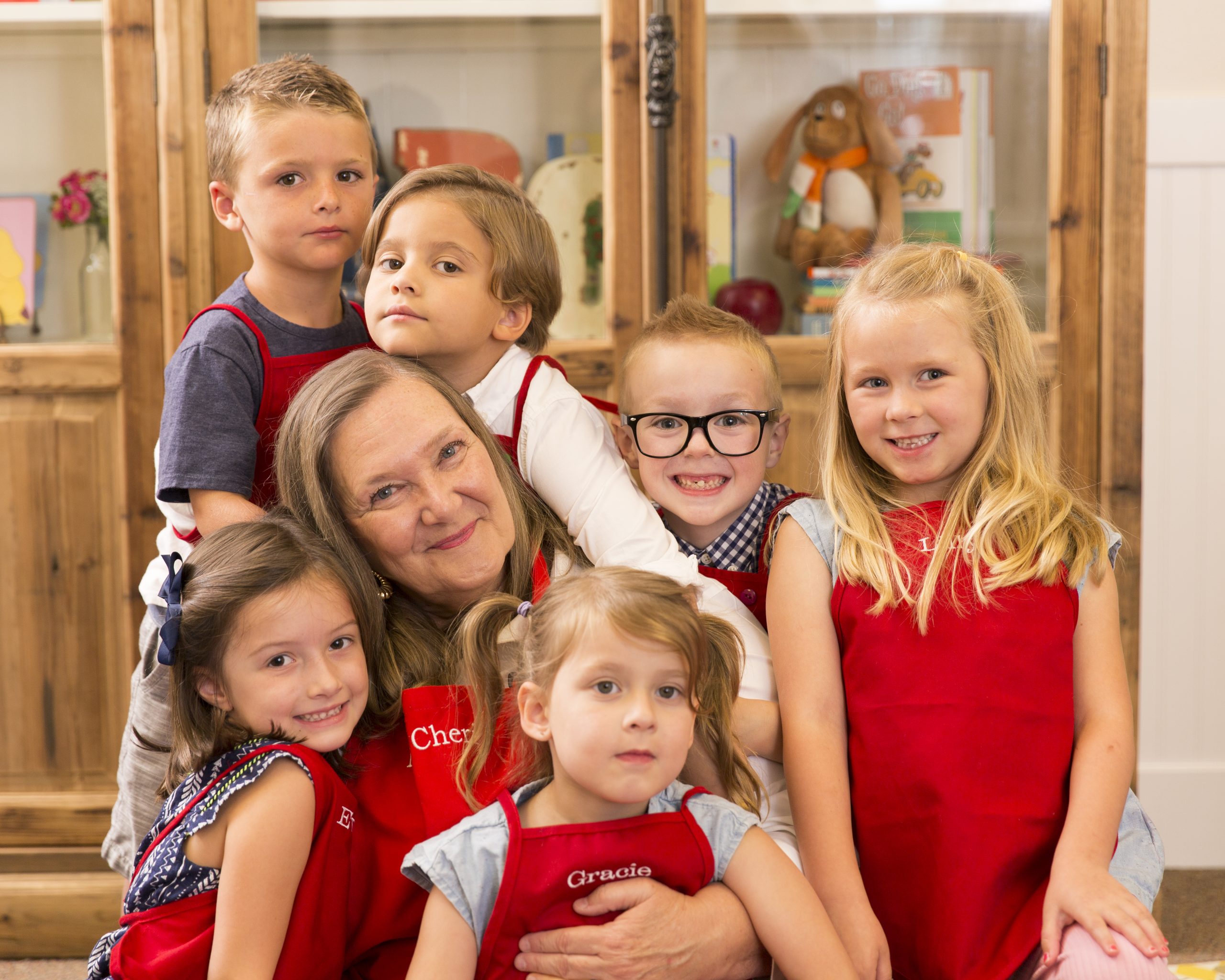 First Day of Preschool Kids Village Teacher surrounded by preschool students